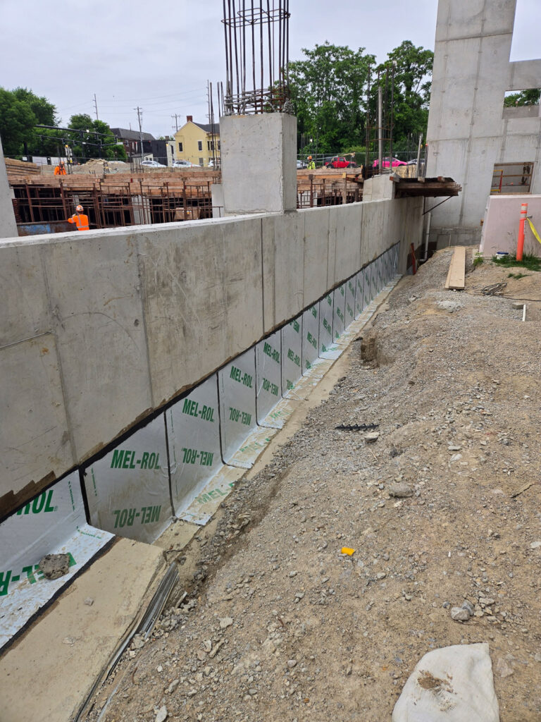 Sheet membrane along the outside face of a concrete foundation wall"