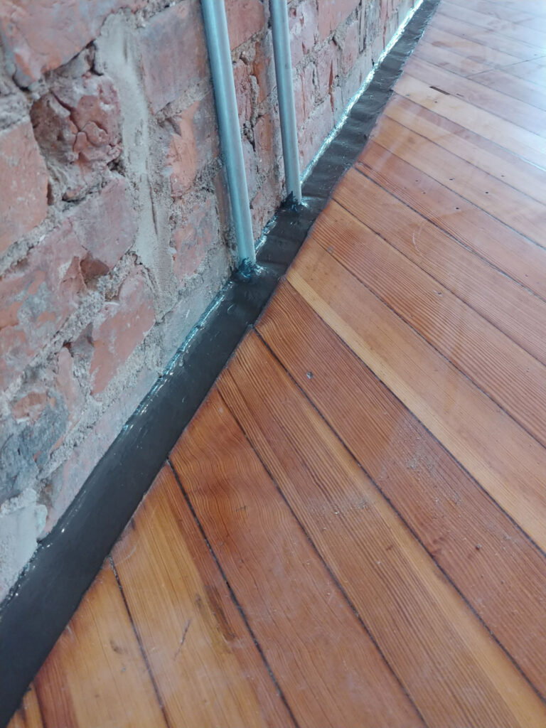 Joint detail between brickwork and a wood floor"