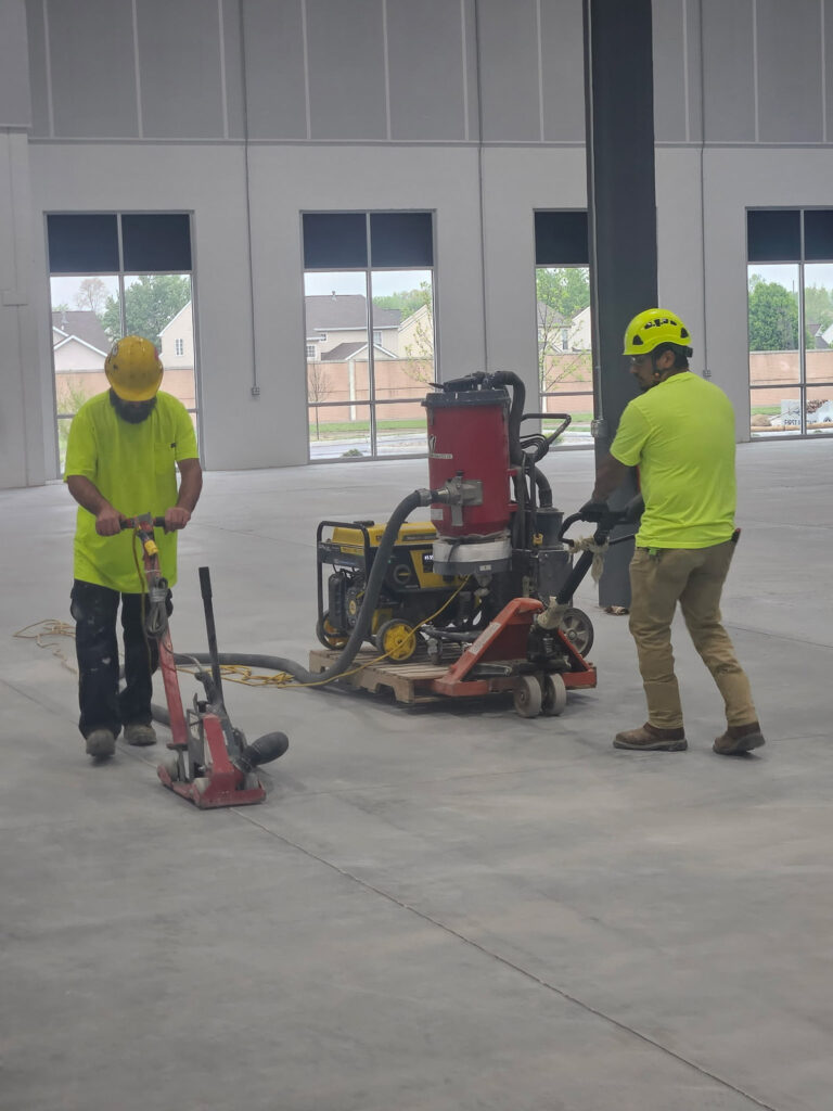 Crew and floor-preparation equipment inside a commercial building"