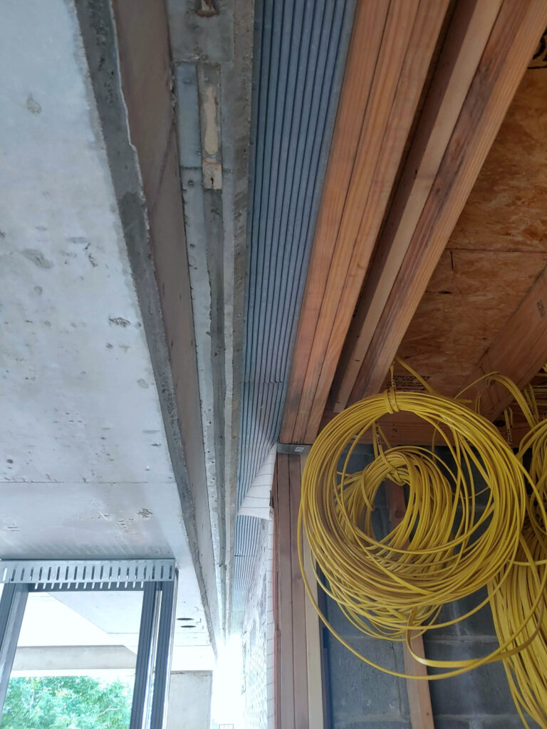 Joint profile beside exposed framing"