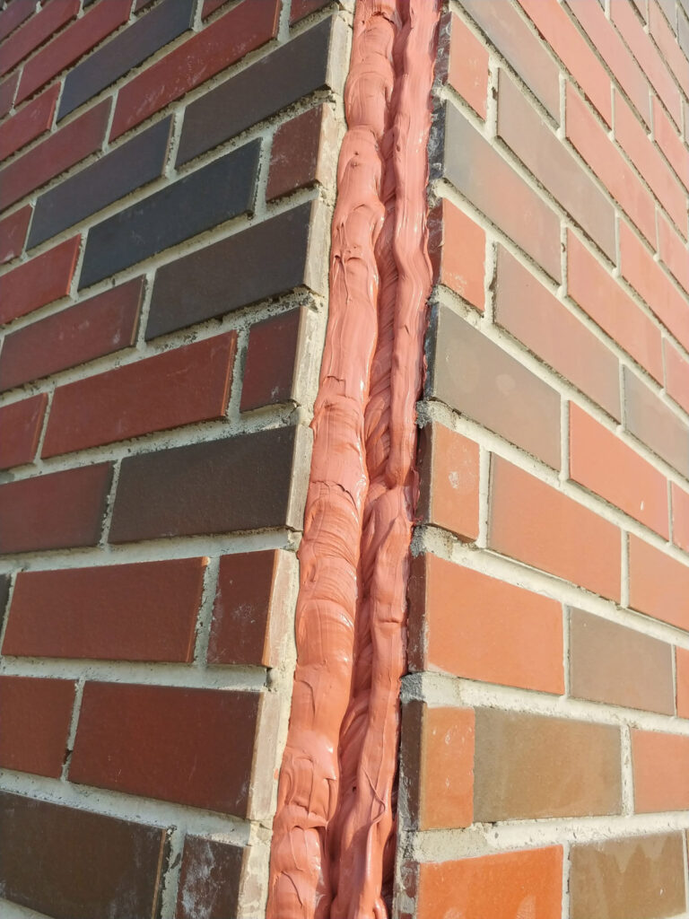 Exposed material in a vertical brick joint"