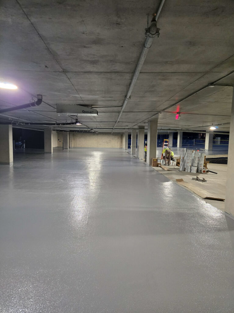 Parking-deck surface with work areas visible in the distance"