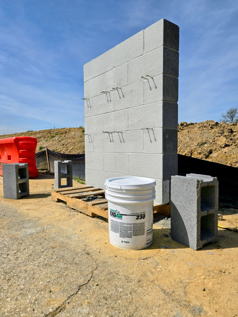 Wall mockup with a Tremco ExoAir 230 container"