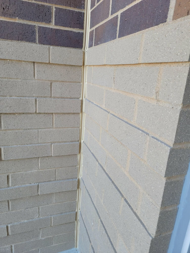 Vertical sealant detail at the junction of masonry walls"