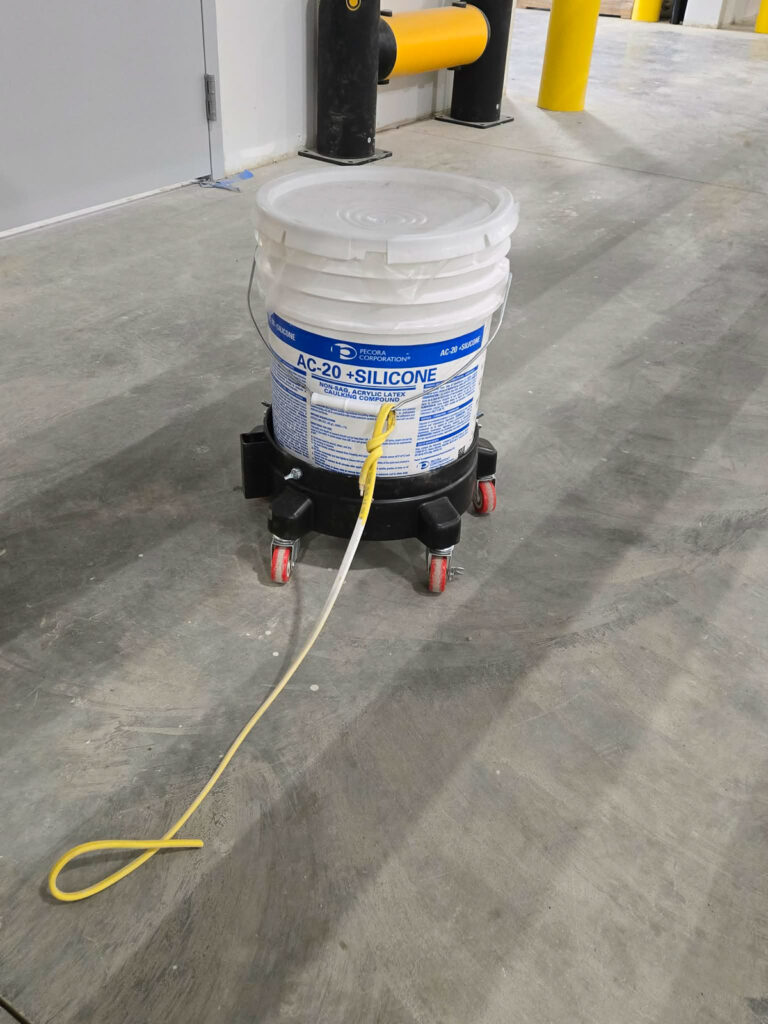 Material-dispensing equipment at a concrete floor joint"