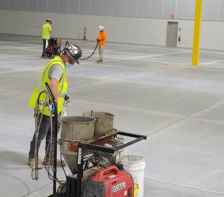 PSI crew & concrete-joint-filling-sealant equipment on a commercial concrete floor.
